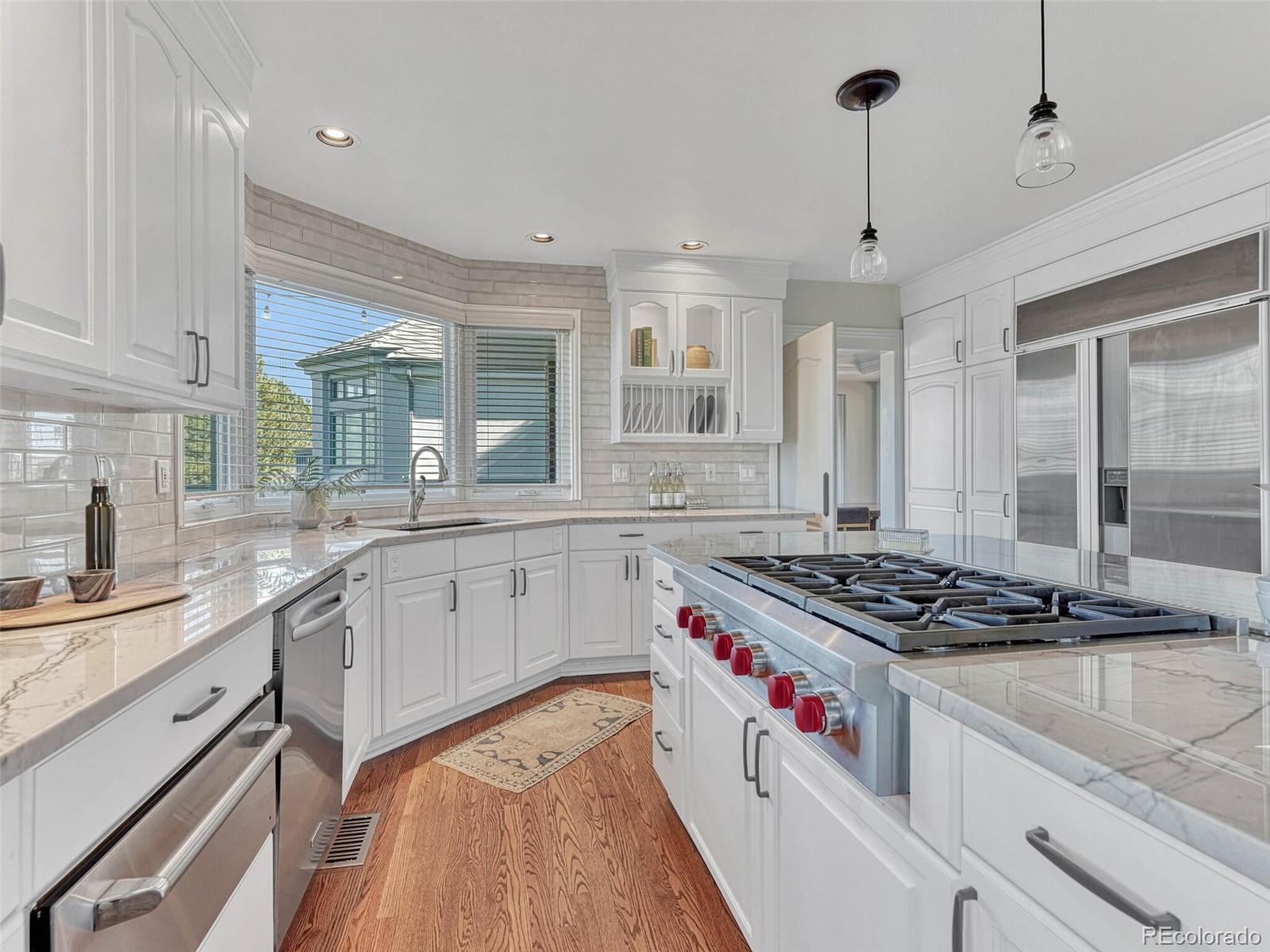 8541 Colonial Drive Lone Tree, CO 80124 - Photo 12 of 45 a kitchen with stainless steel appliances granite countertop a stove and a sink
