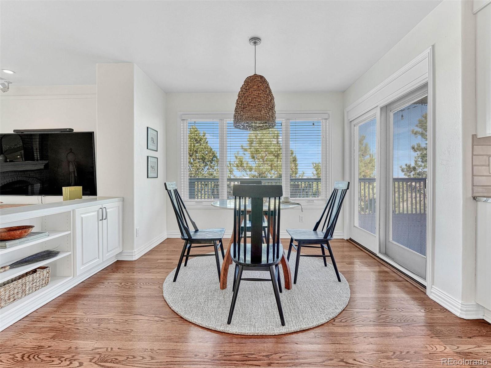 8541 Colonial Drive Lone Tree, CO 80124 - Photo 14 of 45 a dining room with furniture and wooden floor
