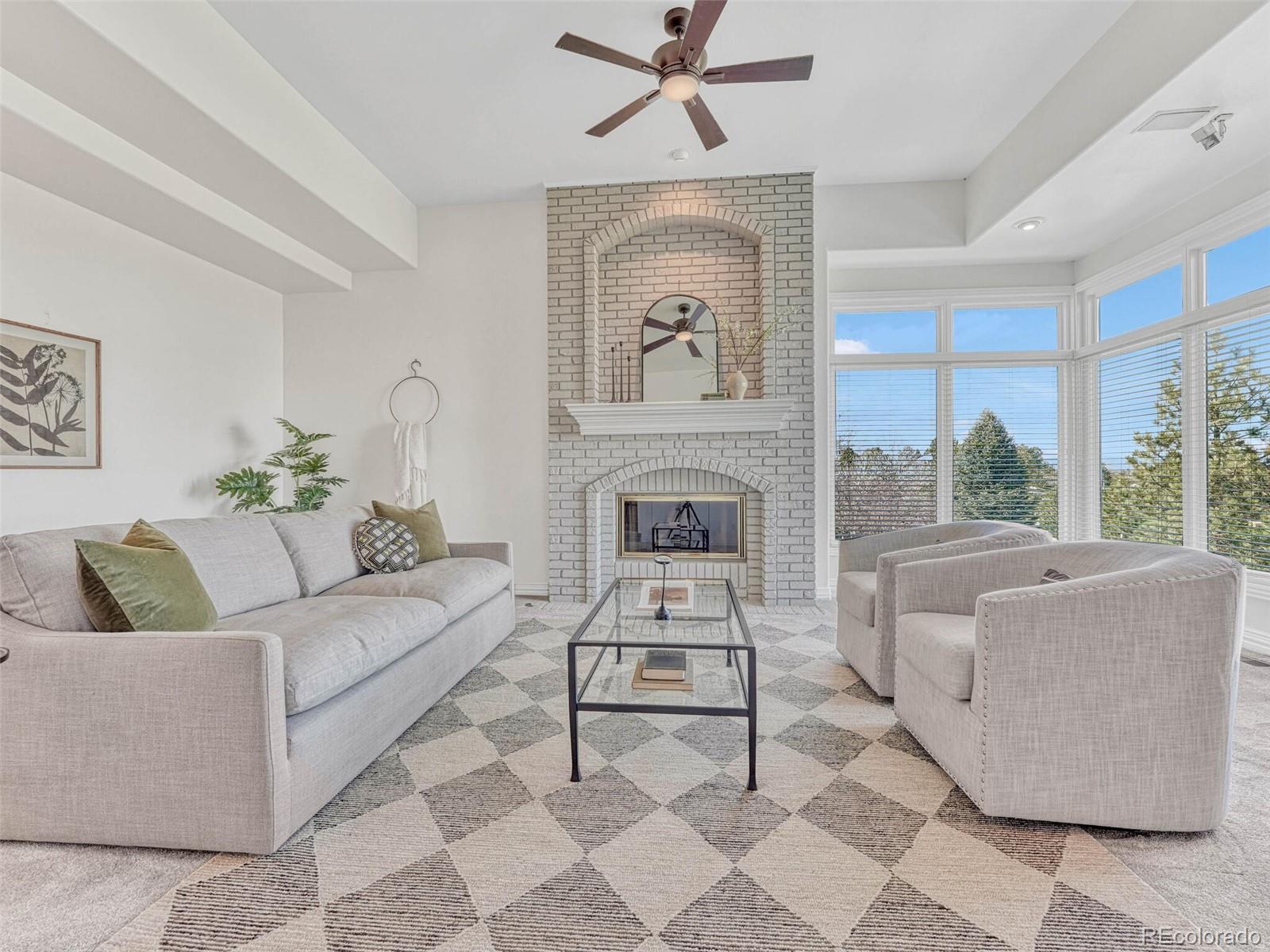 8541 Colonial Drive Lone Tree, CO 80124 - Photo 18 of 45 a living room with furniture and a fireplace