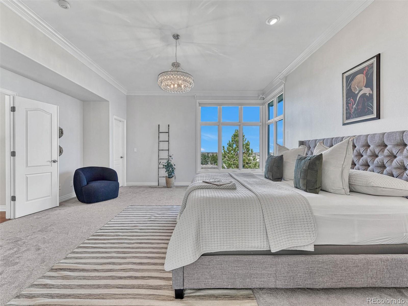 8541 Colonial Drive Lone Tree, CO 80124 - Photo 20 of 45 a bedroom with a large bed and a large window