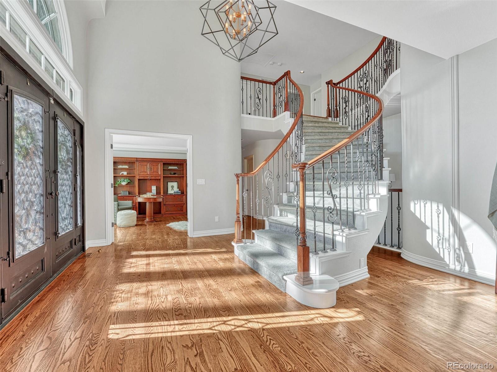 8541 Colonial Drive Lone Tree, CO 80124 - Photo 2 of 45 a view of entryway and hall with wooden floor