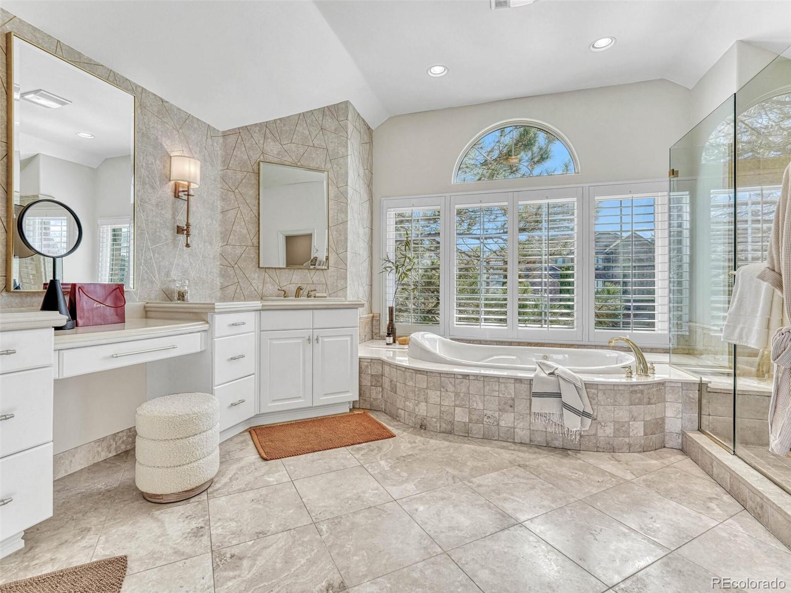 8541 Colonial Drive Lone Tree, CO 80124 - Photo 23 of 45 a spacious bathroom with a tub sink and mirror