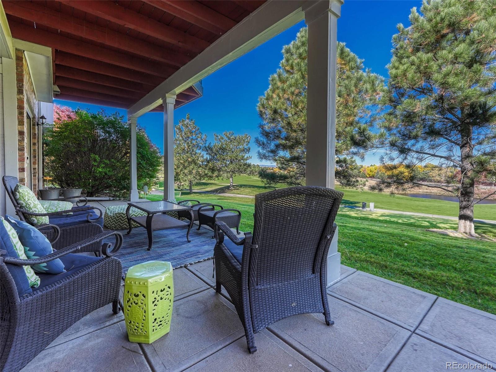 8541 Colonial Drive Lone Tree, CO 80124 - Photo 38 of 45 a view of a patio with couches chairs and a big yard