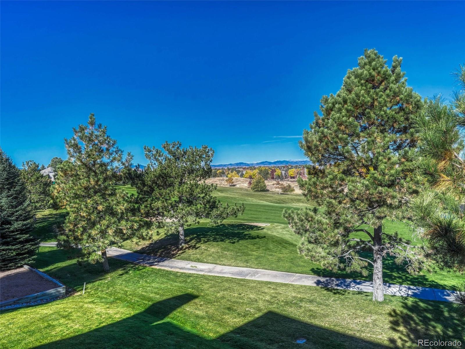 8541 Colonial Drive Lone Tree, CO 80124 - Photo 40 of 45 a view of a garden with a building in the background