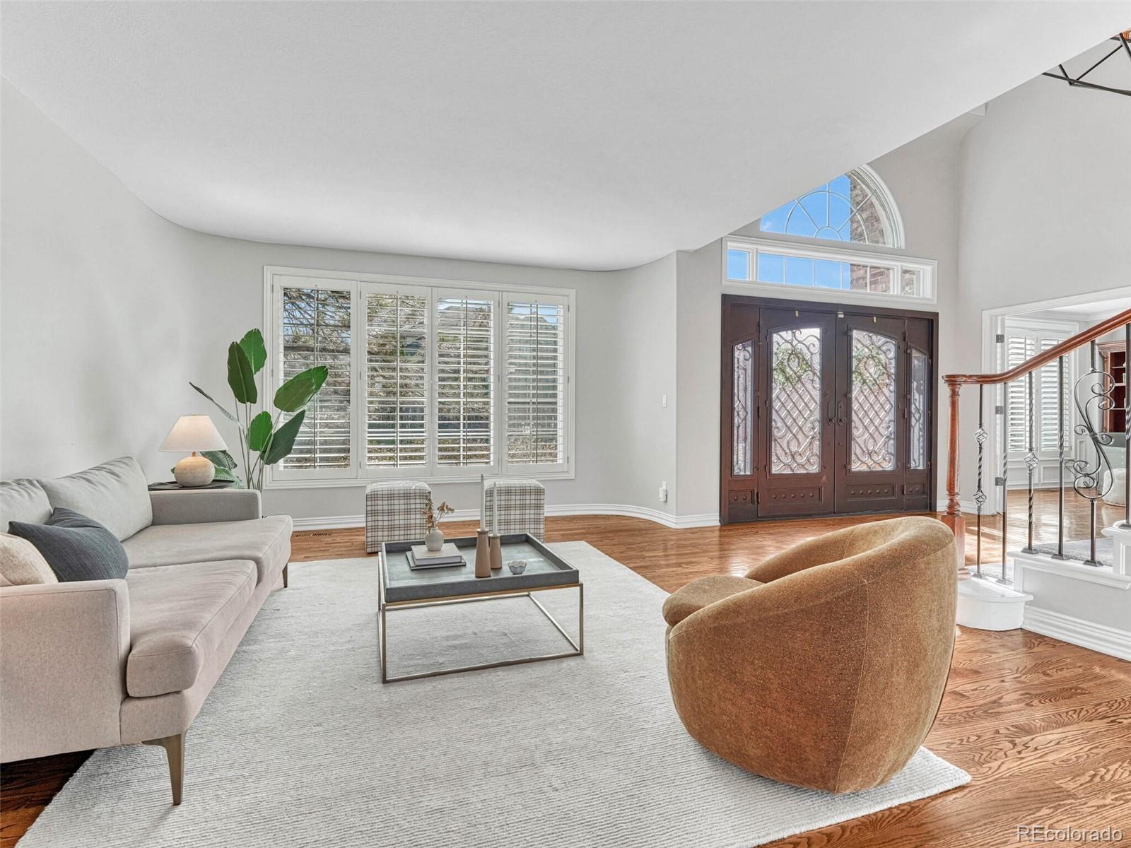 8541 Colonial Drive Lone Tree, CO 80124 - Photo 4 of 45 a living room with furniture and a large window