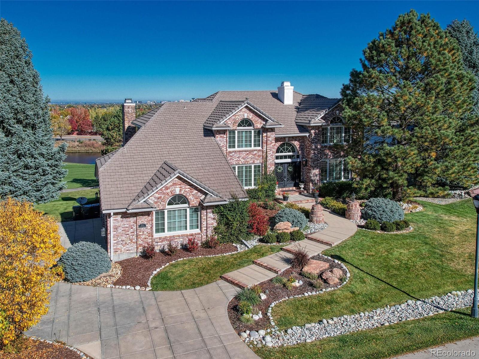 8541 Colonial Drive Lone Tree, CO 80124 - Photo 42 of 45 a front view of a house with garden