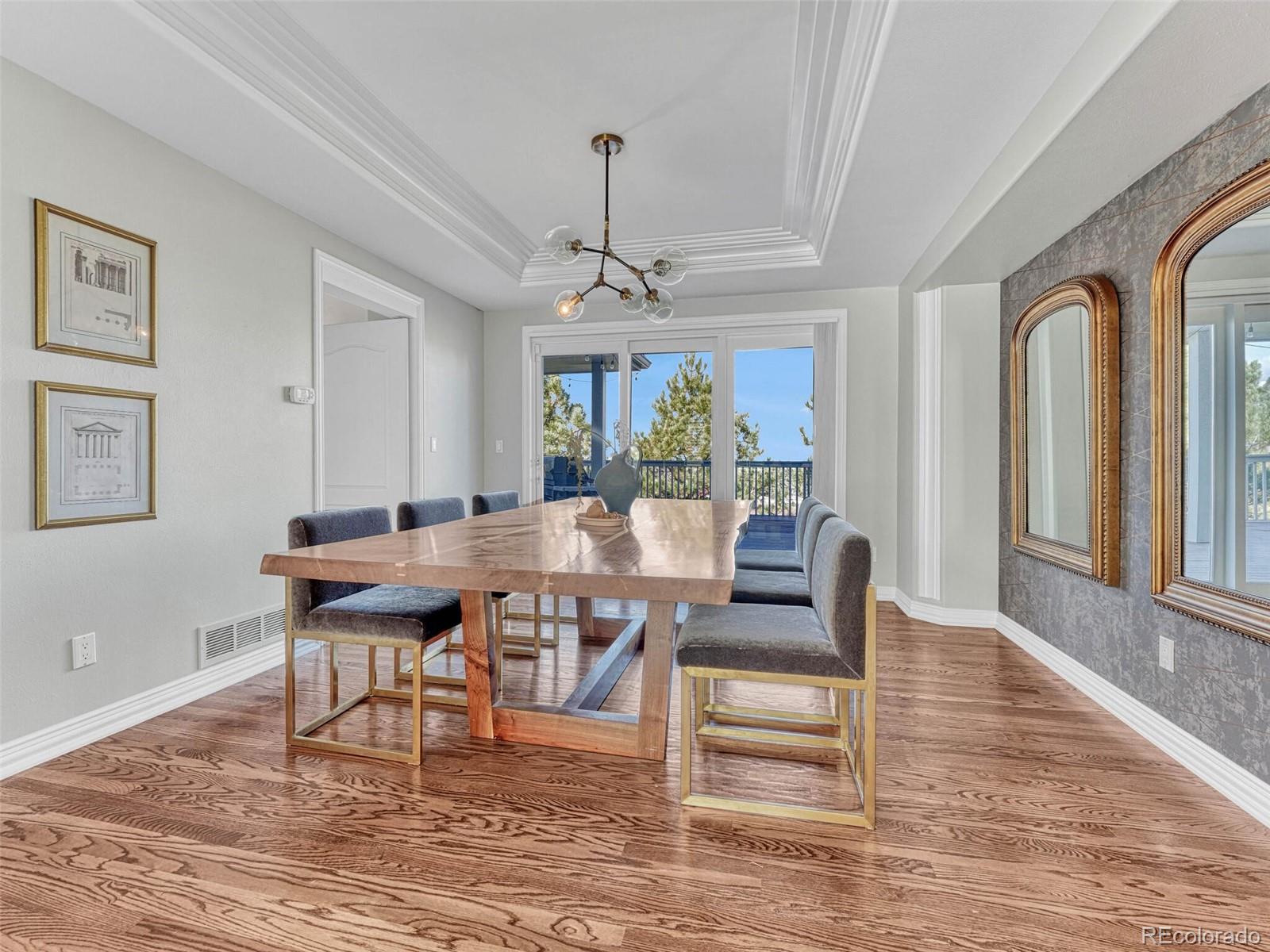 8541 Colonial Drive Lone Tree, CO 80124 - Photo 7 of 45 a living room with couches a dining table and chairs with wooden floor