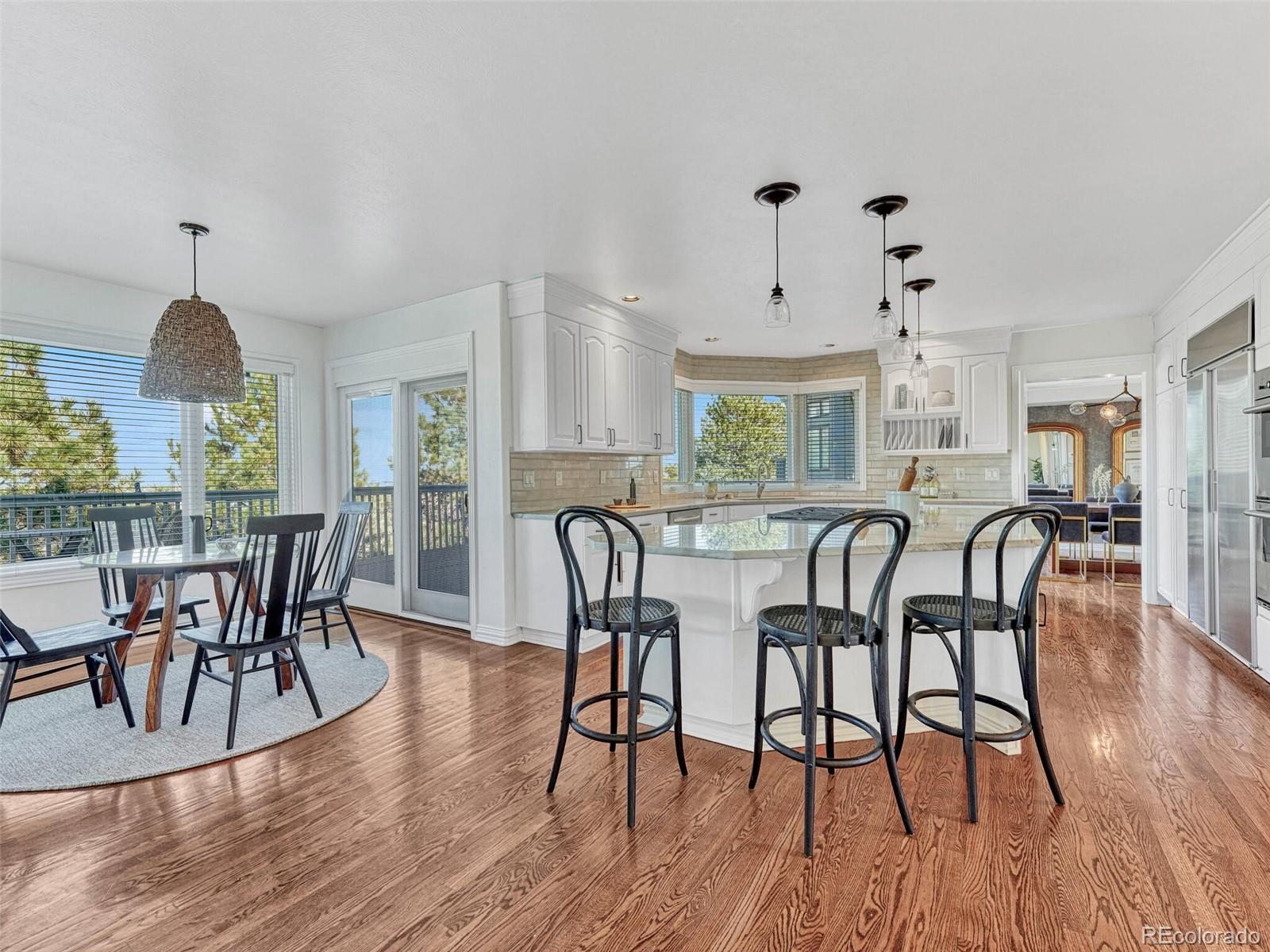 8541 Colonial Drive Lone Tree, CO 80124 - Photo 10 of 45 a dining room with furniture a chandelier and wooden floor