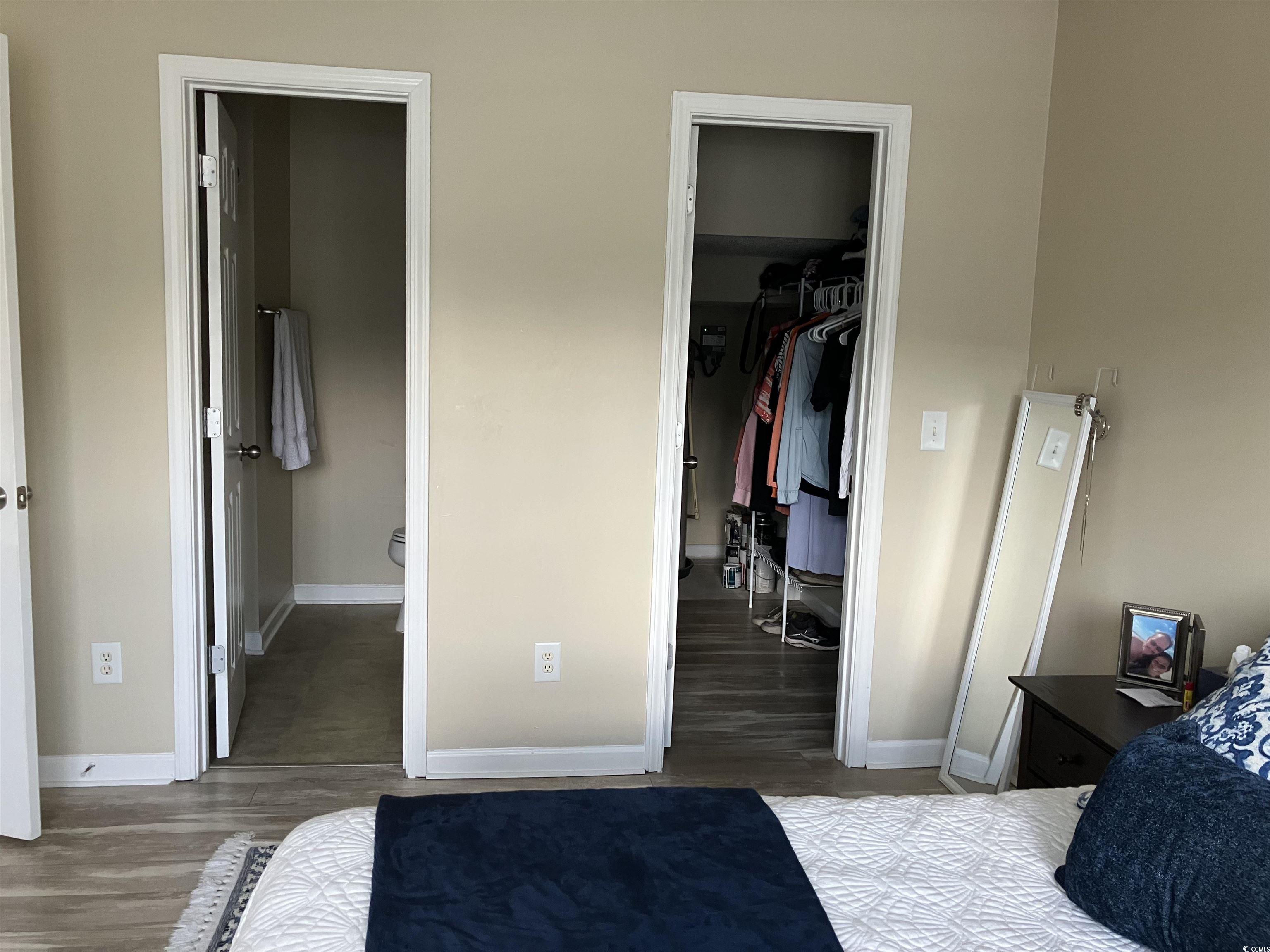 4840 Moss Creek Loop, Unit 31 Murrells Inlet, SC 29576 - Photo 12 of 24 Bedroom featuring a spacious closet and wood finished floors