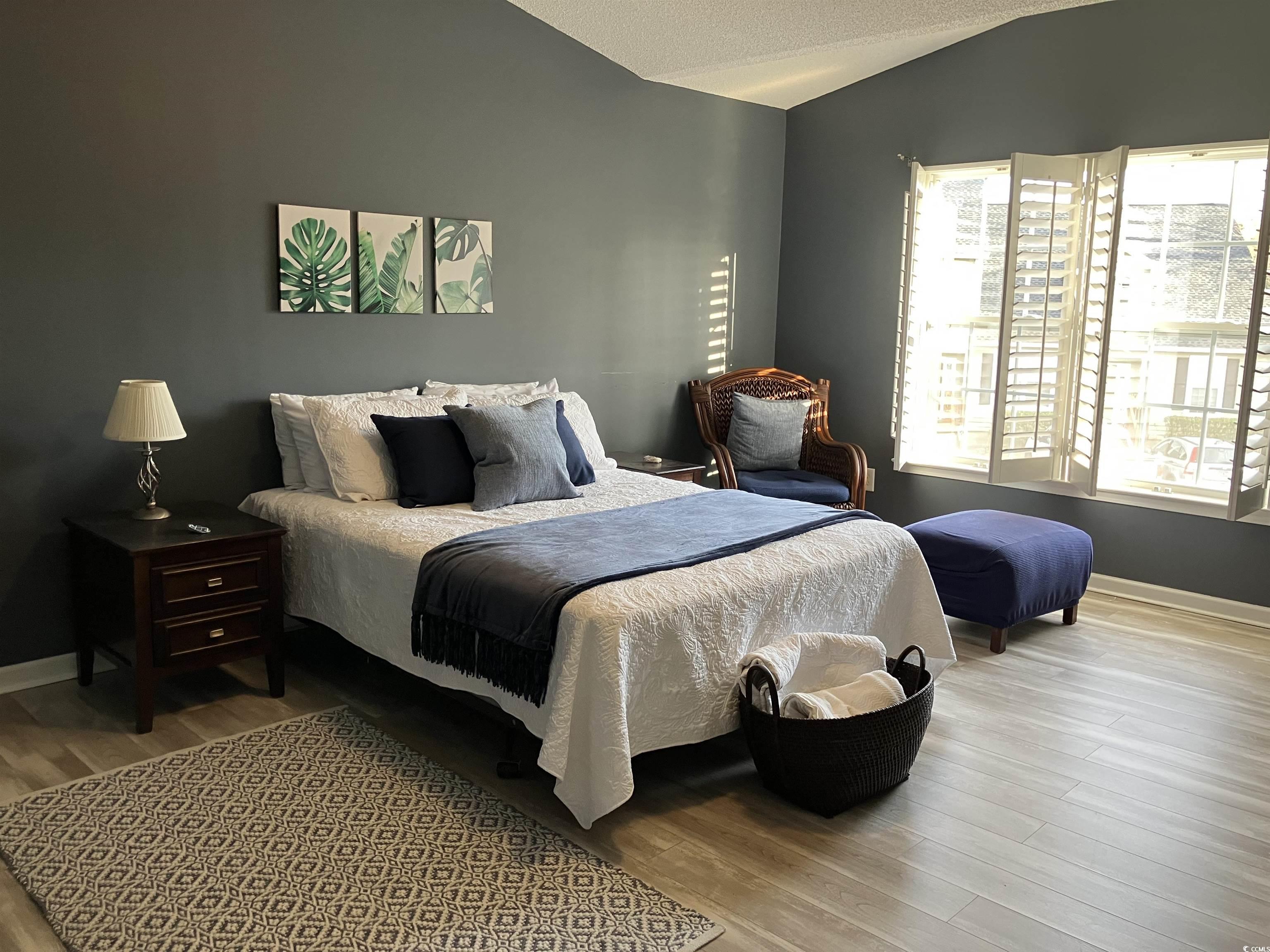 4840 Moss Creek Loop, Unit 31 Murrells Inlet, SC 29576 - Photo 15 of 24 Bedroom featuring vaulted ceiling, wood finished floors, and a textured ceiling