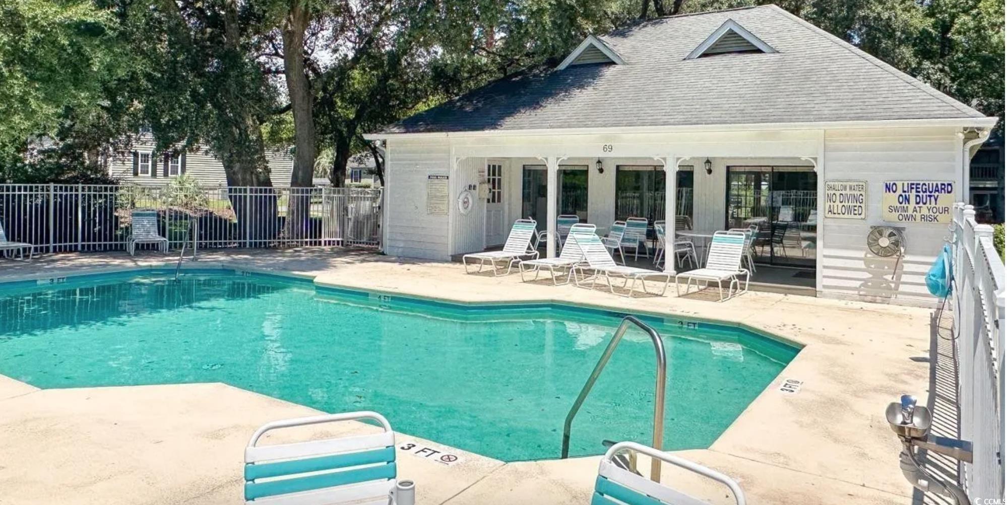 4840 Moss Creek Loop, Unit 31 Murrells Inlet, SC 29576 - Photo 23 of 24 Community pool featuring a patio area, an outdoor structure, and an exterior structure