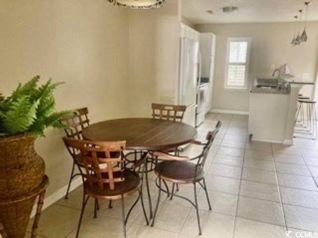 4840 Moss Creek Loop, Unit 31 Murrells Inlet, SC 29576 - Photo 3 of 24 Dining area featuring light tile patterned floors and a chandelier