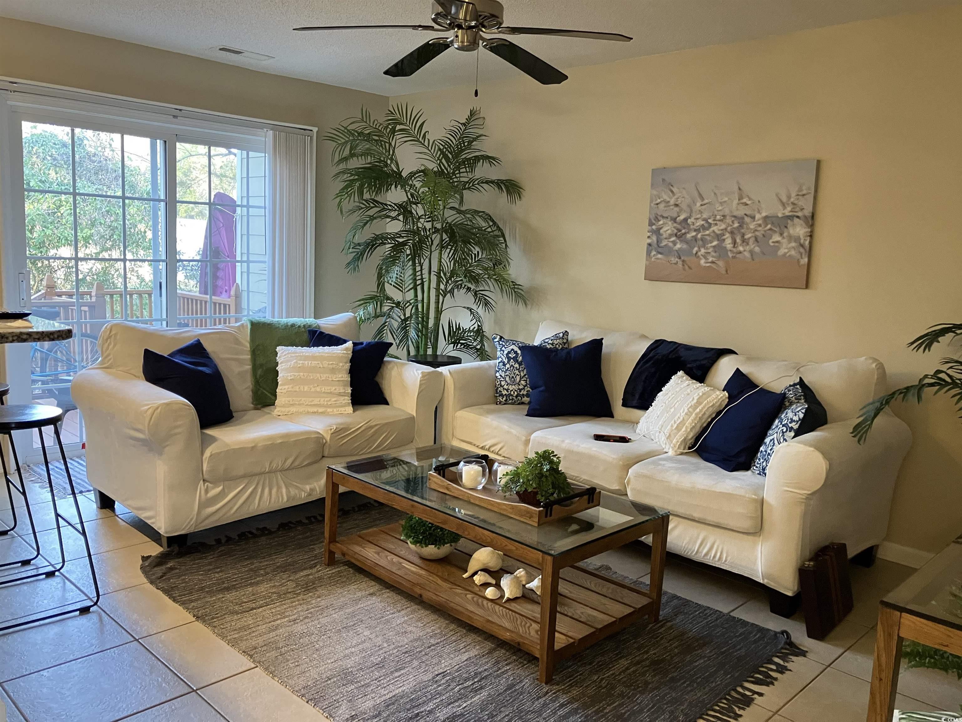 4840 Moss Creek Loop, Unit 31 Murrells Inlet, SC 29576 - Photo 4 of 24 Living room featuring light tile patterned flooring and a ceiling fan
