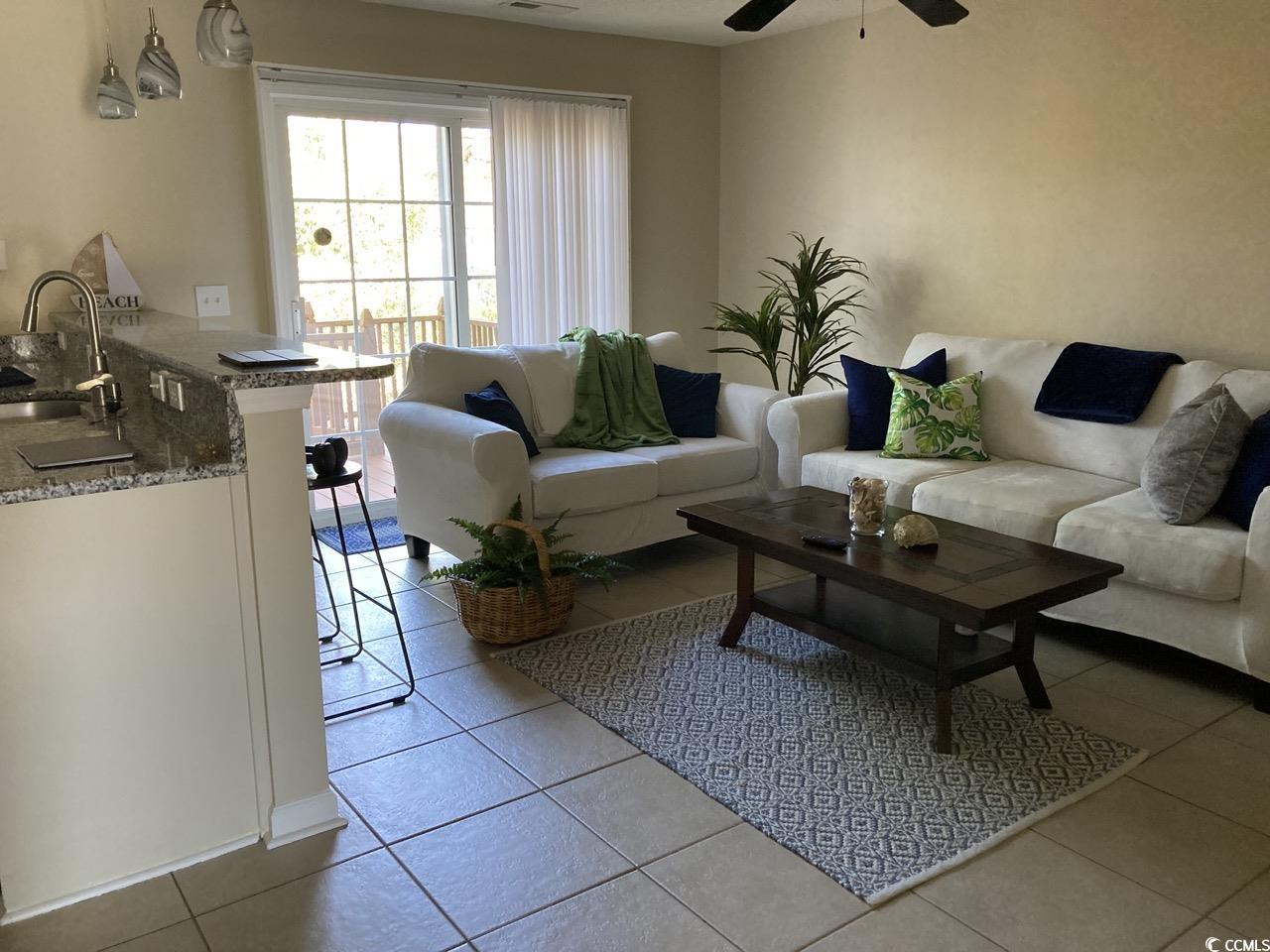 4840 Moss Creek Loop, Unit 31 Murrells Inlet, SC 29576 - Photo 6 of 24 Living room featuring light tile patterned flooring and a ceiling fan
