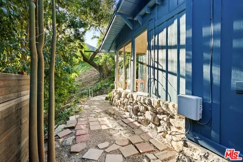 a balcony with wooden floor and outdoor seating