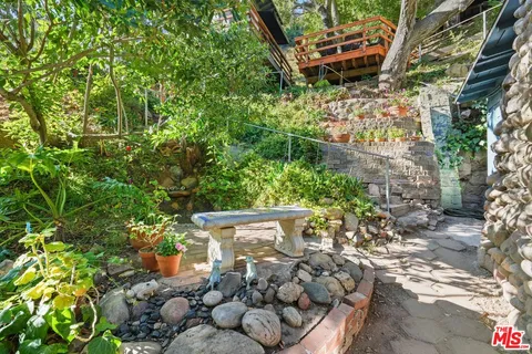 a bed room with a bed and a view of living room