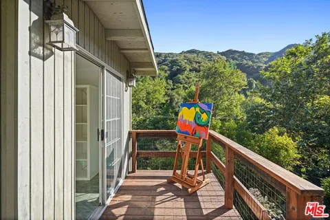 a view of balcony with wooden floor