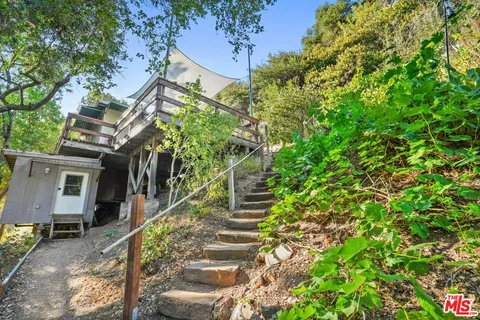 a view of a lush green field with mountains in the background