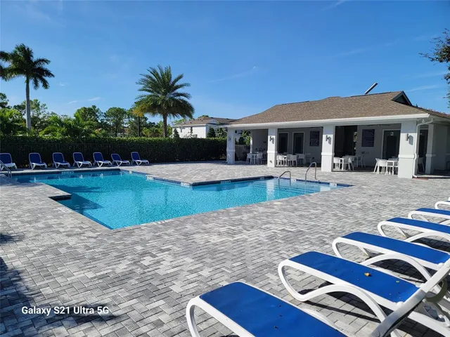 a view of a house with swimming pool and sitting area