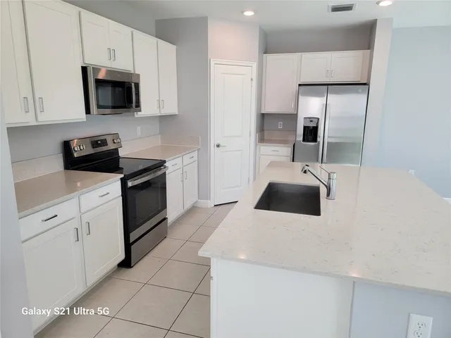 a kitchen with cabinets and stainless steel appliances
