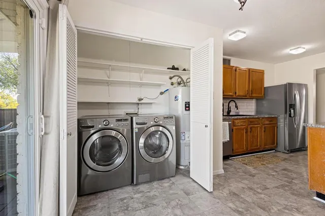 a view of a kitchen with refrigerator and sink