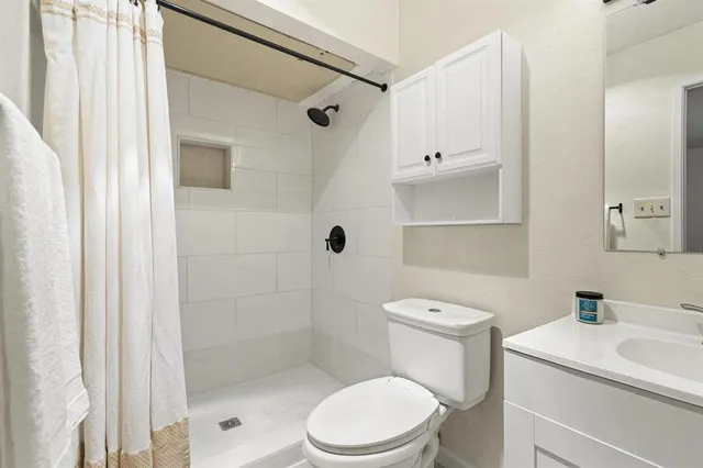 a white toilet sitting next to a bathroom sink