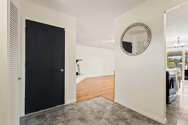 a view of a livingroom with wooden floor and a bathroom