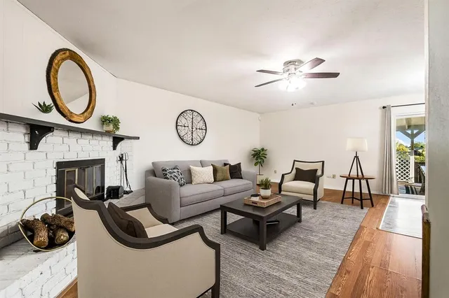 a living room with furniture a fireplace and a flat screen tv