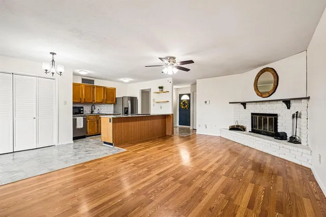 a view of a kitchen with a sink and a fireplace