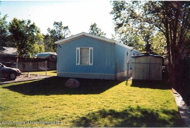 a view of a backyard with a large tree