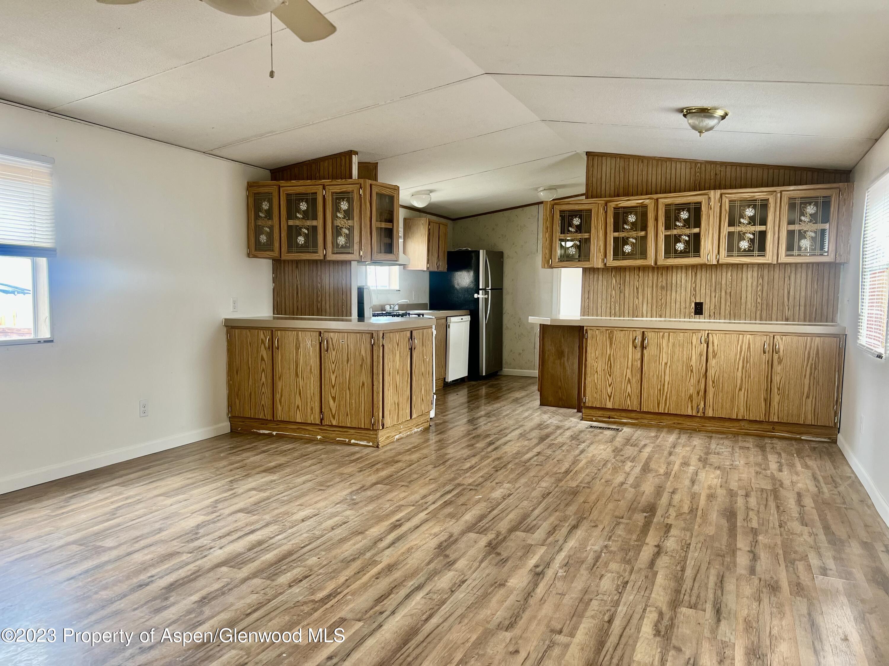 346 Greig Avenue De Beque, CO 81630 - Photo 5 of 15 a view of a room with wooden floor and furniture