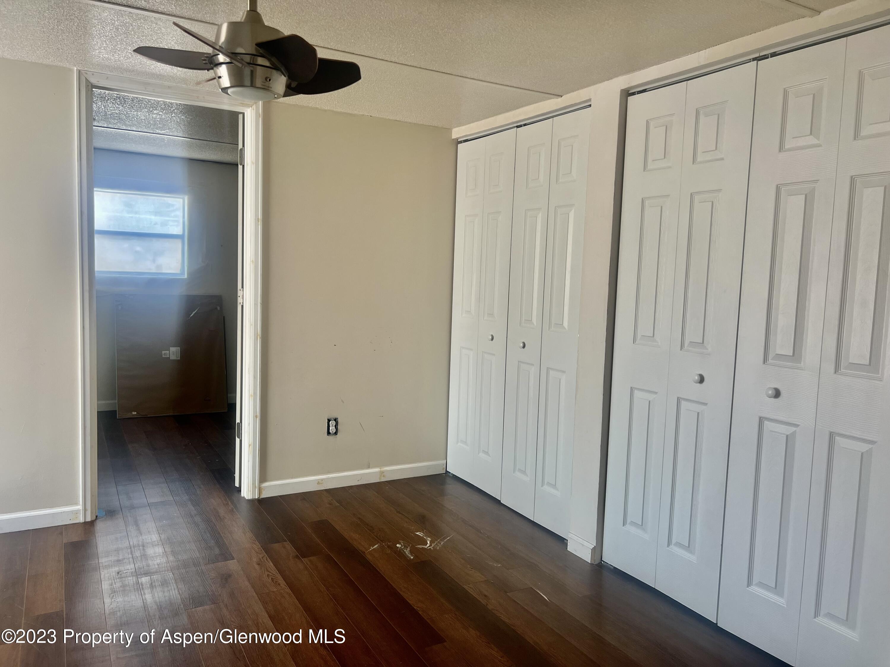 346 Greig Avenue De Beque, CO 81630 - Photo 8 of 15 a view of an empty room with wooden floor