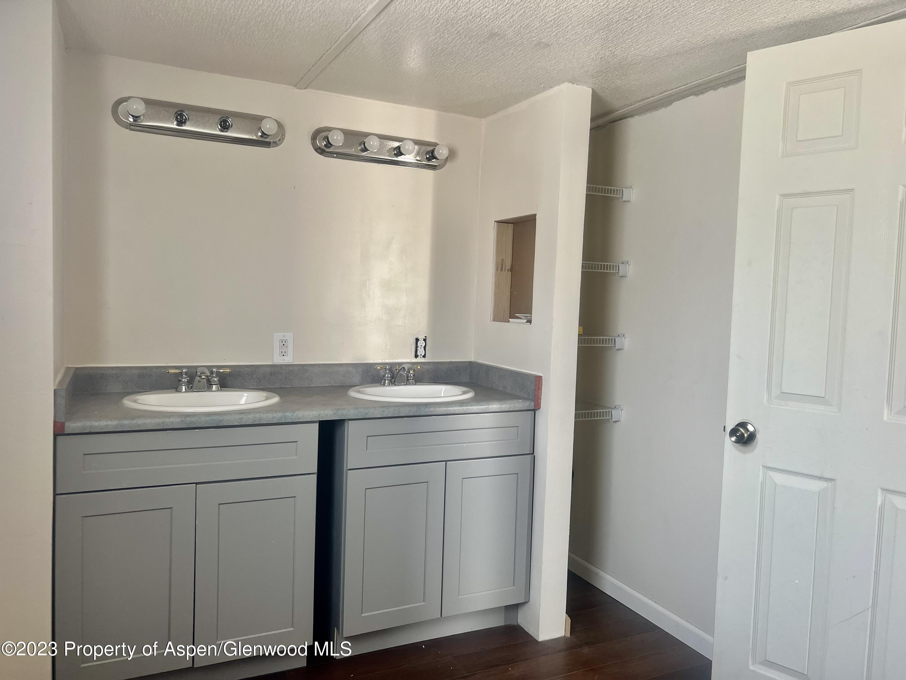 346 Greig Avenue De Beque, CO 81630 - Photo 10 of 15 a bathroom with a granite countertop sink and a mirror