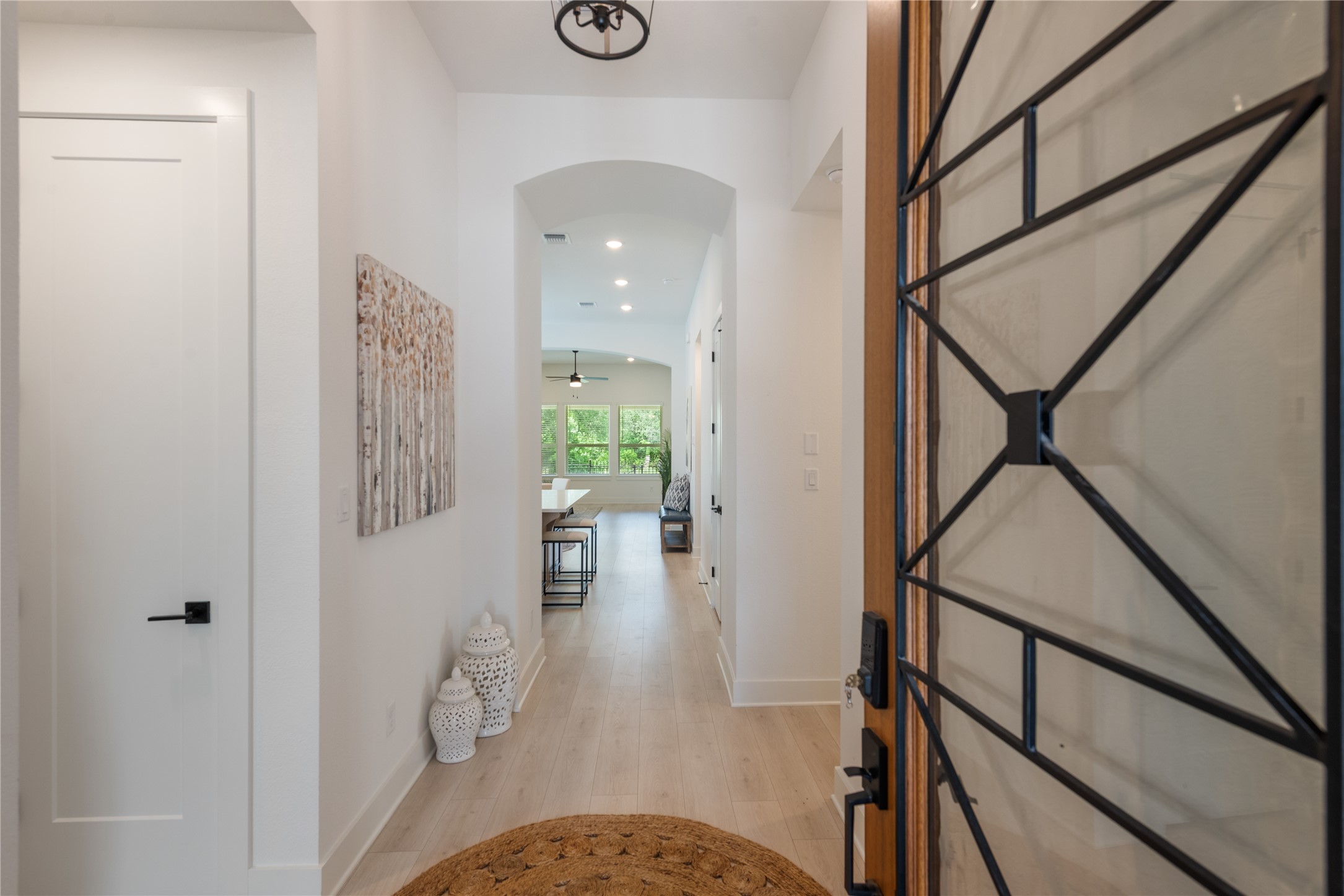 294 Kimble Creek Loop Kyle, TX 78640 - Photo 2 of 40 Enter into a bright hallway featuring light-toned flooring and recessed lighting.