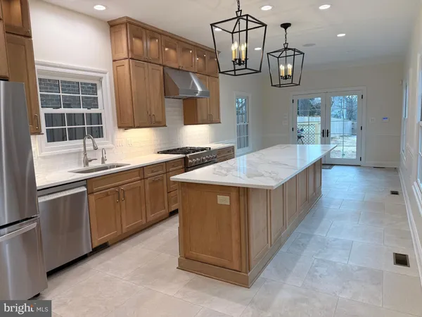 a kitchen with stainless steel appliances granite countertop a sink and a stove