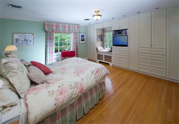 458 Chestnut Street Newton, MA 02468 - Photo 11 of 17 a bedroom with a bed closet and flat tv screen