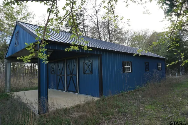 a backyard of a house with plants and tree