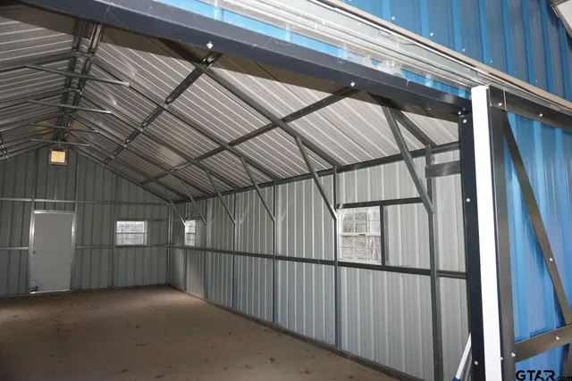 a view of a dry yard with trees