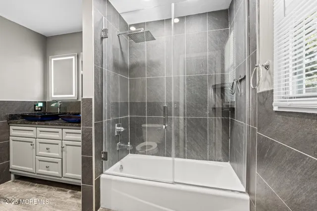 a bathroom with a bathtub and a shower