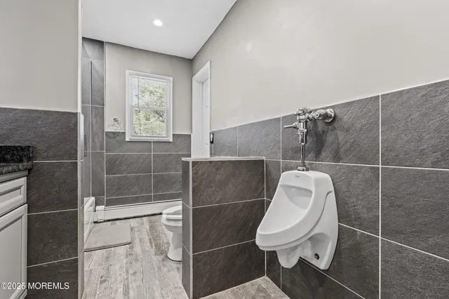 a bathroom with a toilet and a shower