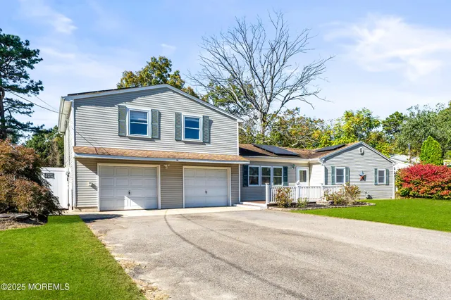 a front view of house with yard and green space