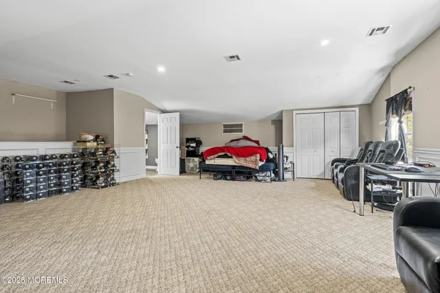 a view of a livingroom with furniture and cars