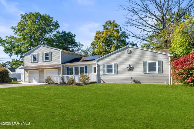 a front view of house with yard and green space