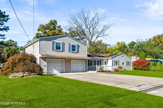 a front view of house with yard and green space