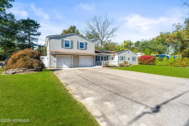a front view of house with yard and green space
