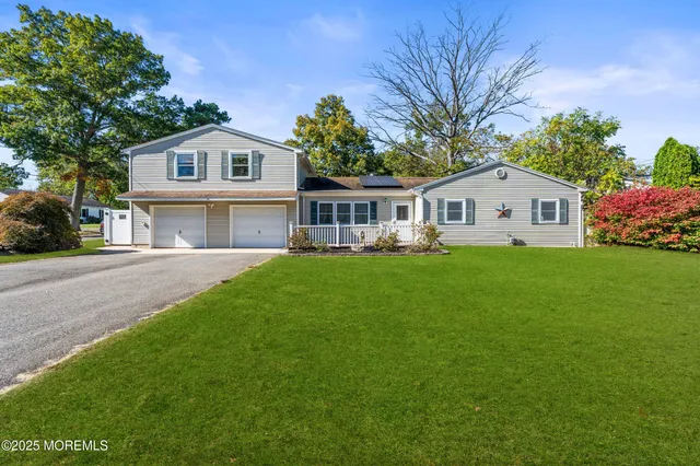 a front view of house with yard and green space