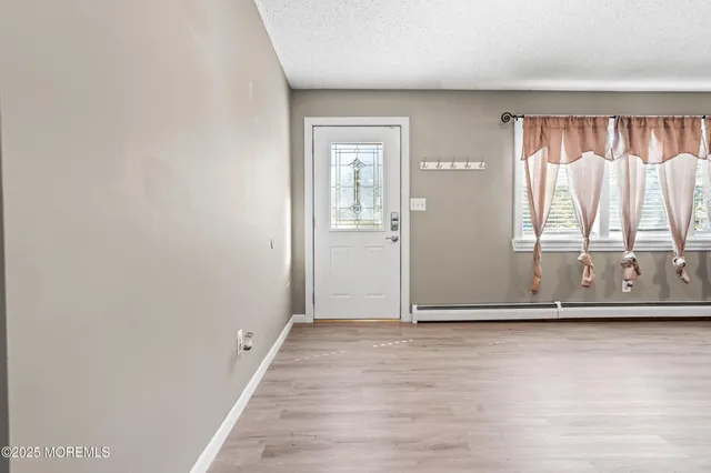 a view of wooden floor with a window