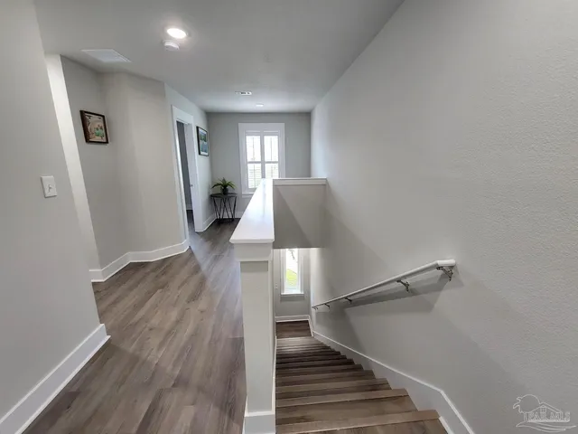 a view of entryway and hall with wooden floor