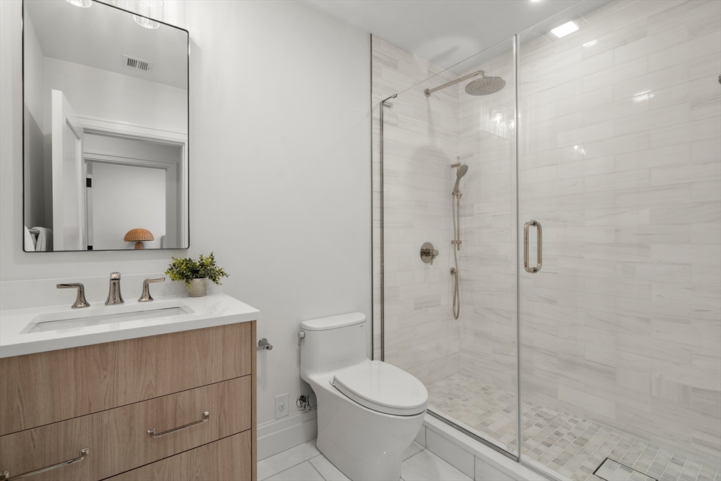 28 Parker Road Wellesley, MA 02482 - Photo 31 of 32 a bathroom with a toilet sink vanity and shower