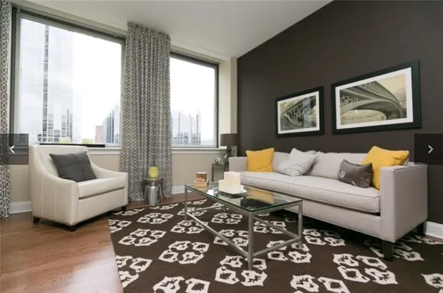 a living room with furniture and a large window